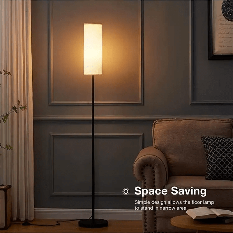 Elegant RGB floor lamp with linen shade illuminating a cozy living room corner.