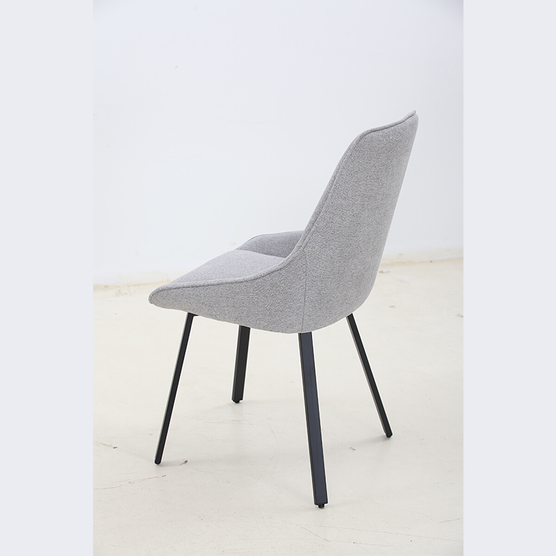Gray adjustable upholstered dining chair from a side angle, showcasing its ergonomic design.