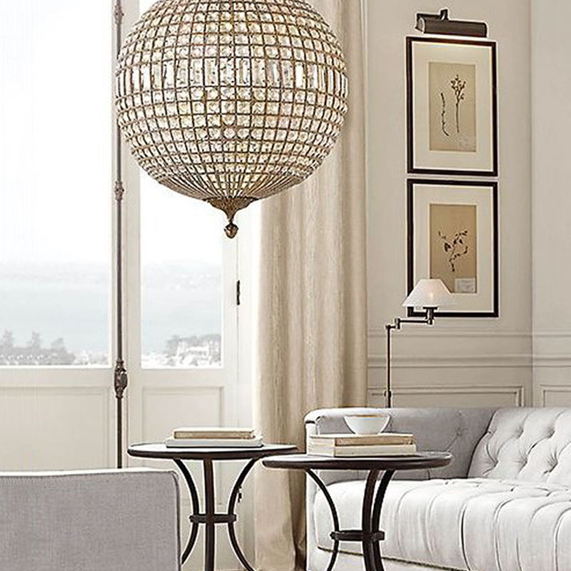 Elegant LED crystal pendant lamp in a cozy living room setting.