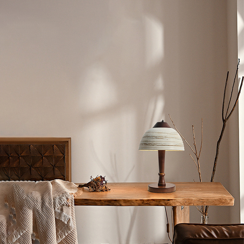 Elegant Chinese ceramic table lamp showcasing its wooden base in a cozy reading nook.