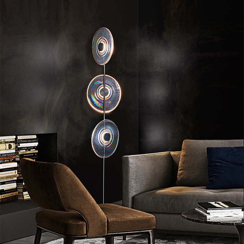 Sleek modern glass LED floor lamp in a stylish living room setting.