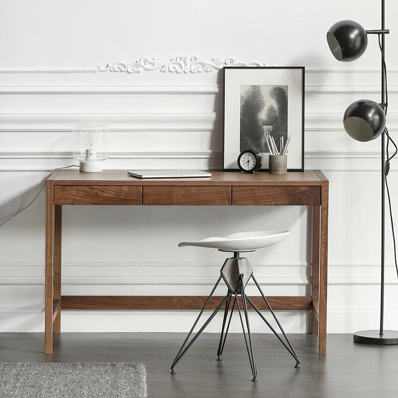Front view of the modern walnut writing desk showing its sleek design and hidden storage.