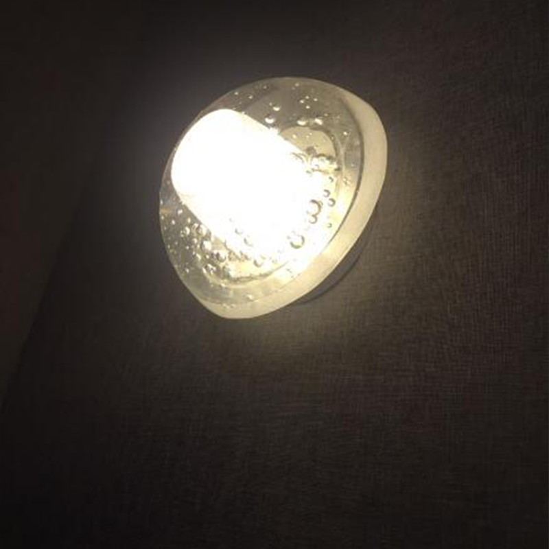 Close-up of the elegant LED dome-shaped wall lamp showcasing the crystal design
