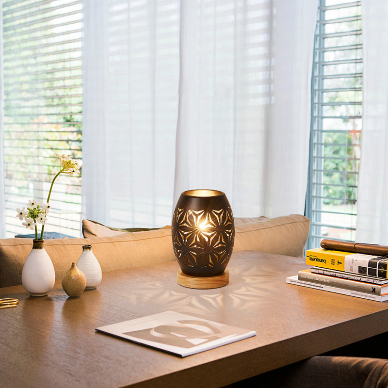 Elegant black LED decorative table lamp on a stylish coffee table, showcasing its modern design.