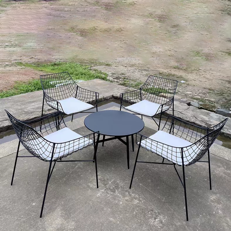 Sleek stainless steel outdoor armchair with gray cushion, ideal for garden relaxation.