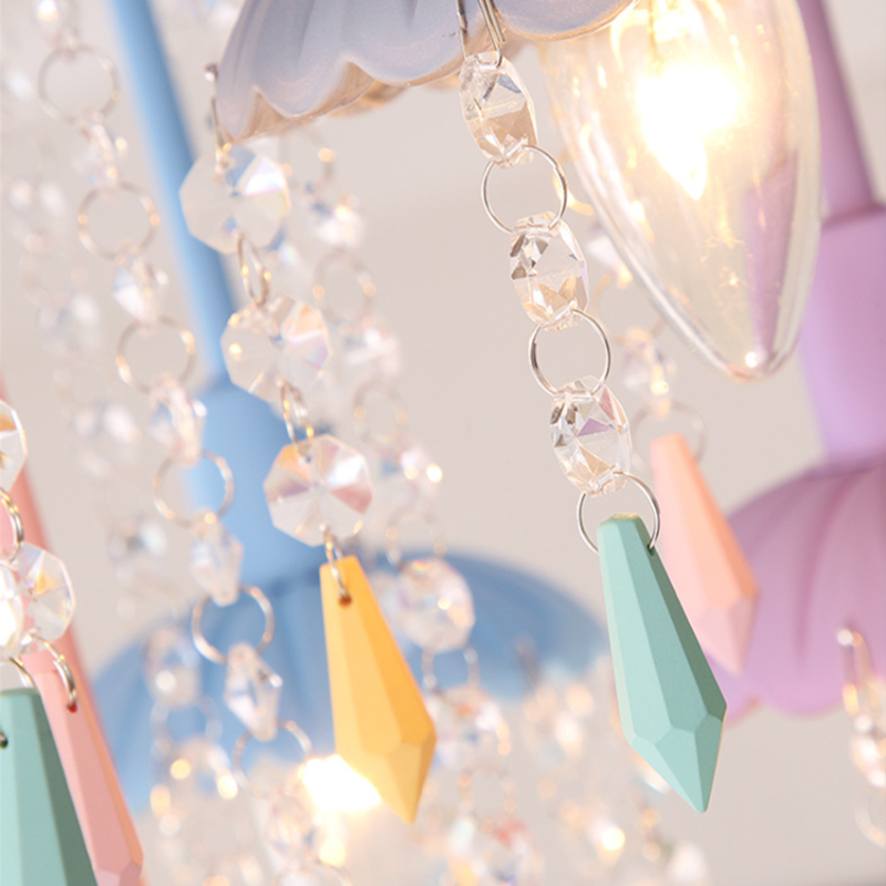 The Macaron chandelier illuminated in a cozy living room setting.