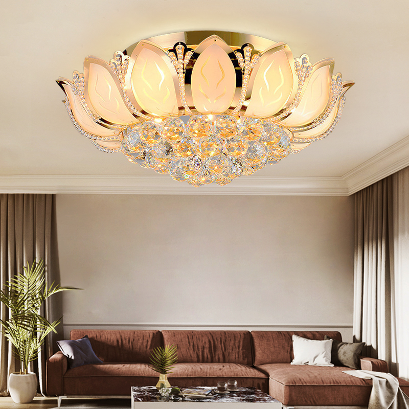 Elegant gold lotus flower ceiling light showcasing its crystal shade in a stylish living room.