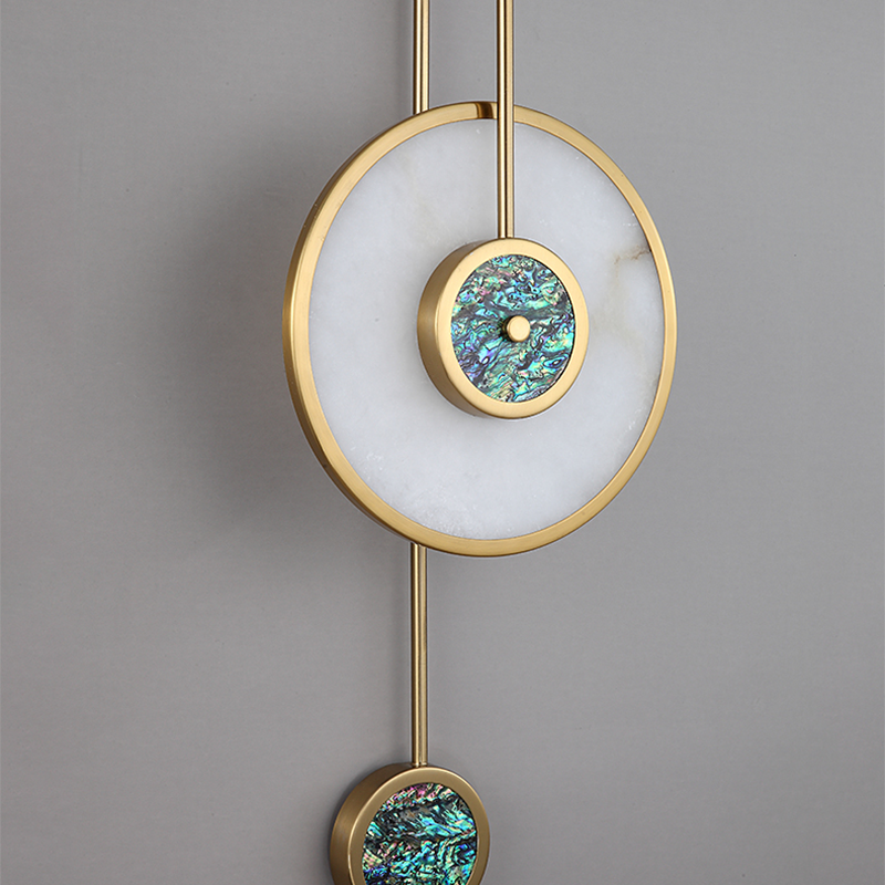 Elegant gold copper wall sconce illuminating a stylish hallway, adding warmth and ambiance.