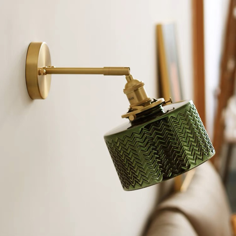 The green glass lamp highlighted in a stylish hallway, demonstrating its decorative appeal.