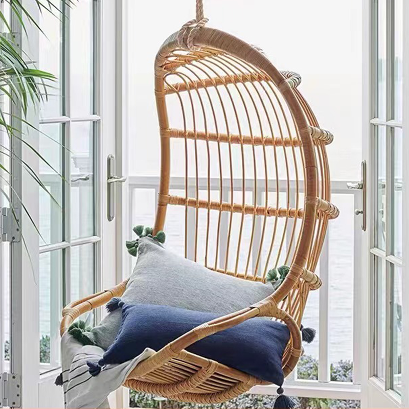 Side view of the rocking chair, highlighting its elegant curves and durable cane frame.