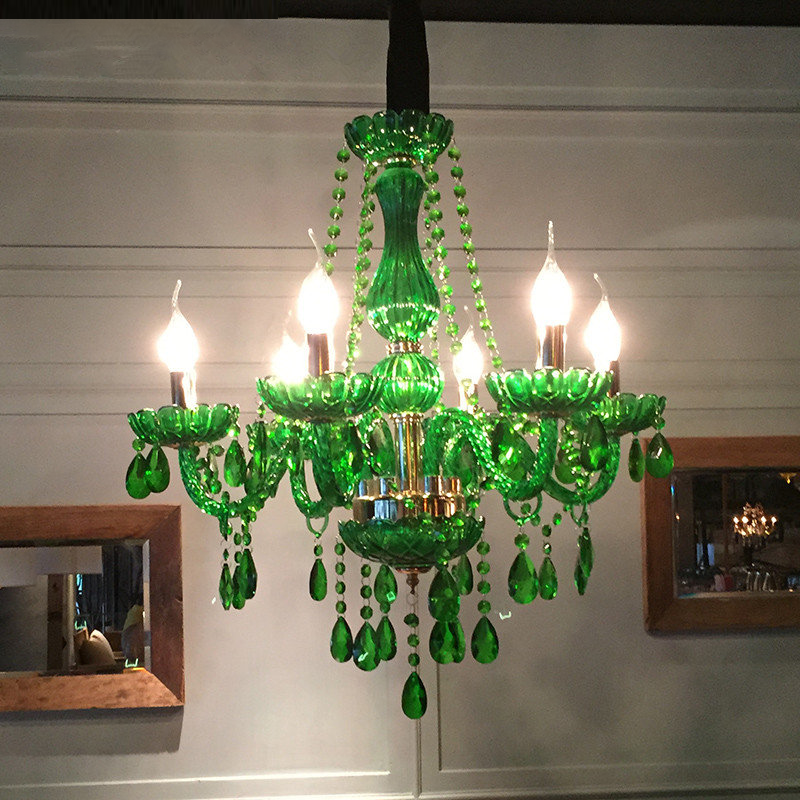Elegant green LED crystal chandelier in a stylish dining room setting.