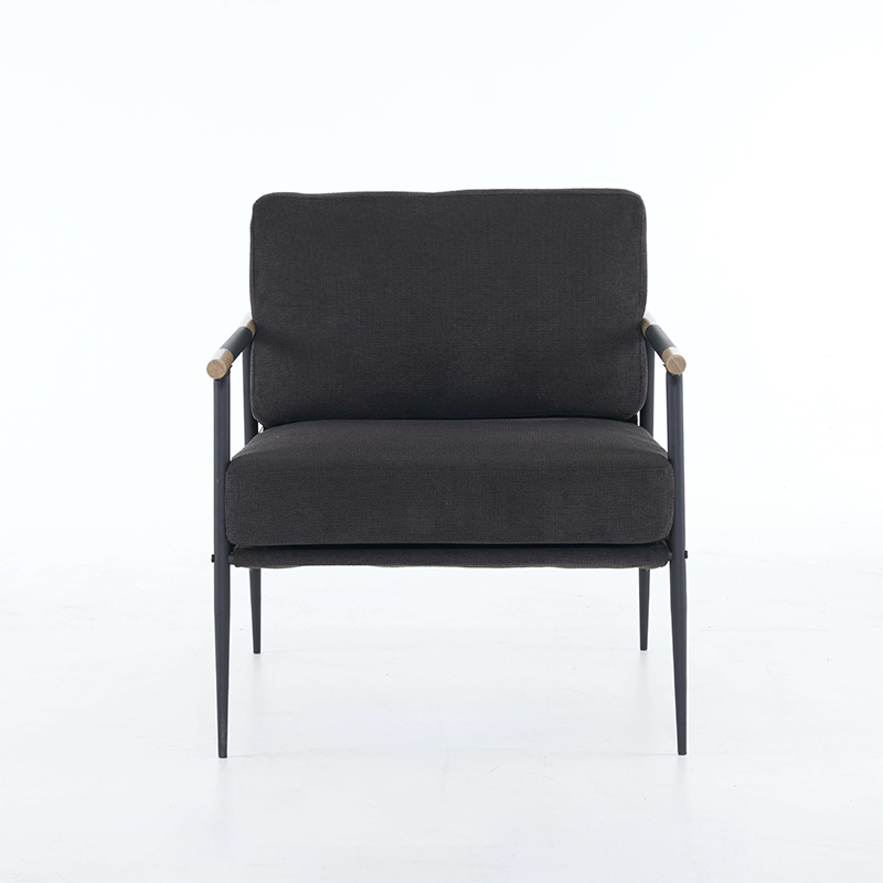 The black chenille lounge chair positioned in an office environment, showcasing its modern design.