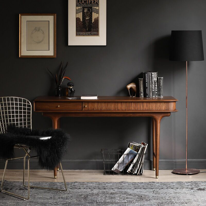 Nut-brown industrial style writing desk from a side angle, highlighting its smooth surface and sturdy drawers.