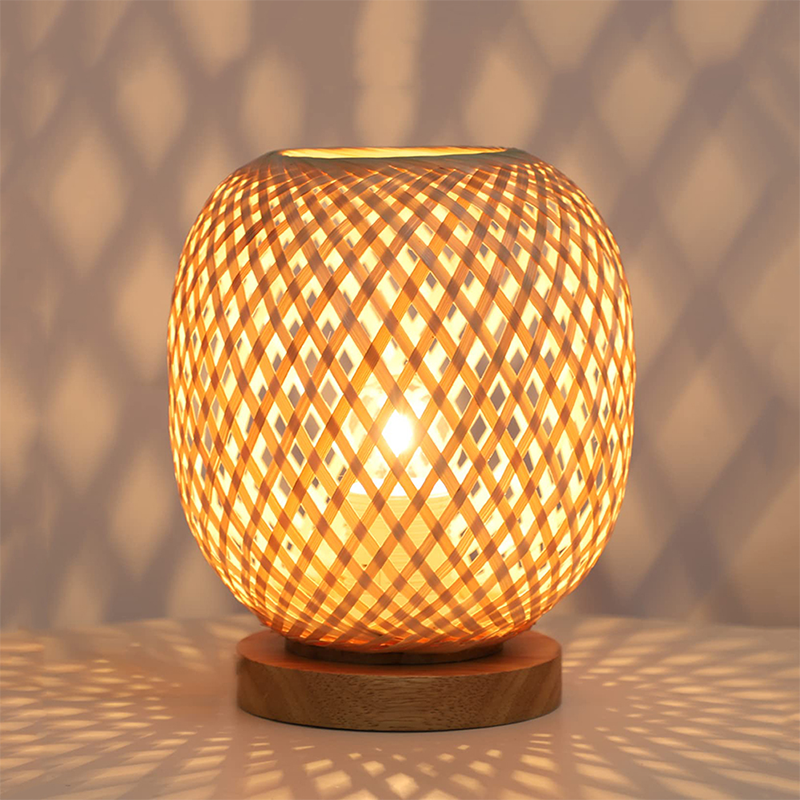Dimmable handwoven rattan table lamp showcasing its intricate design, perfect for a cozy bedroom environment.