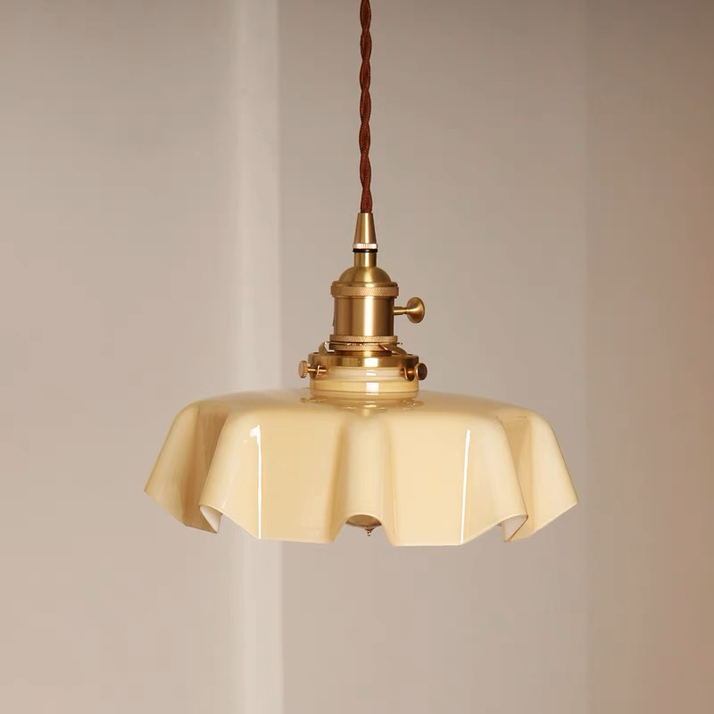 Wavy glass pendant light hanging in a stylish kitchen, showcasing its elegant design.