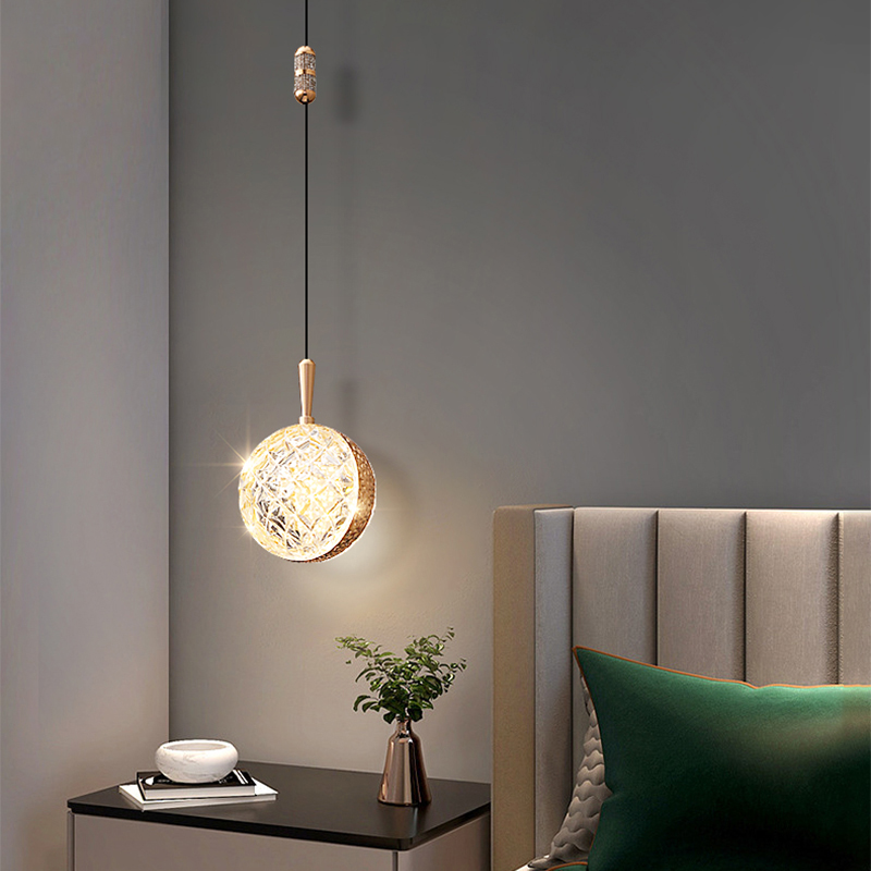 Close-up of gold pendant light showing soft LED glow and sleek metal finish