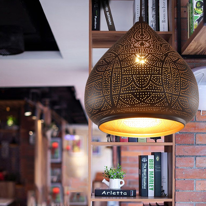 Close-up view of the industrial chic iron pendant light highlighting the hollow-carved shade.