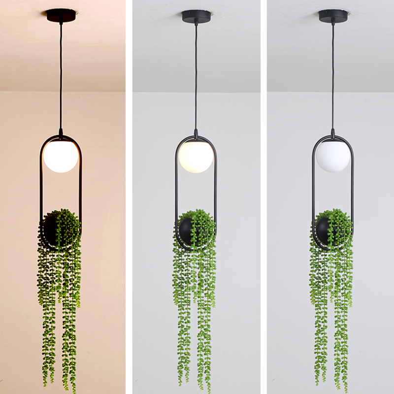 View of the pendant light installed in a cozy bedroom corner with vibrant plants.