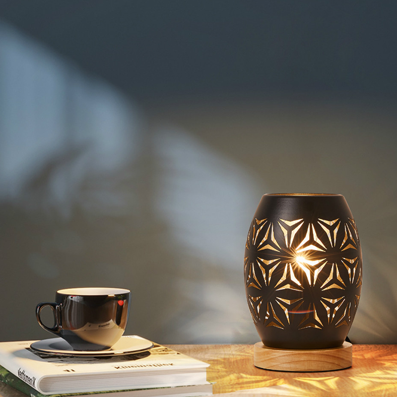 Close-up of the touch control feature on the elegant black patterned table lamp, perfect for bedside use.