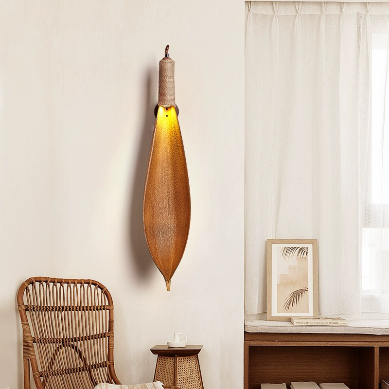 Close-up view of the natural leaf texture and polished finish of the wall lamp.