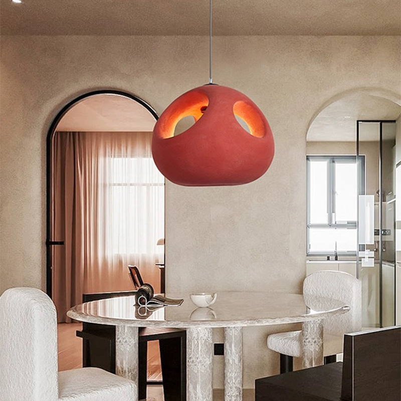 Nordic handwoven pendant light showcasing its intricate design and warm red hue.