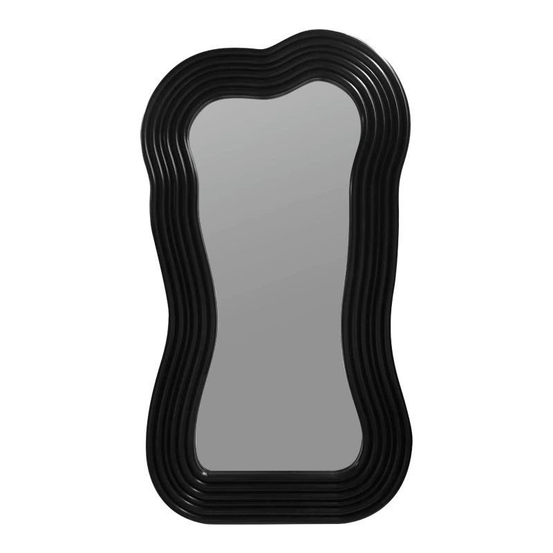 Close-up of the black frame of the floor mirror highlighting its modern design.
