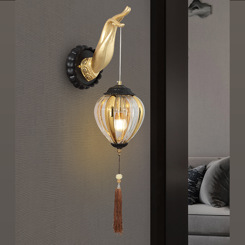 Buddha hand wall lamp mounted in a serene study environment.