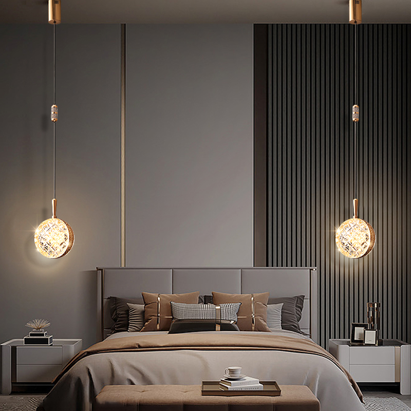 Close-up of gold pendant light showing soft LED glow and sleek metal finish