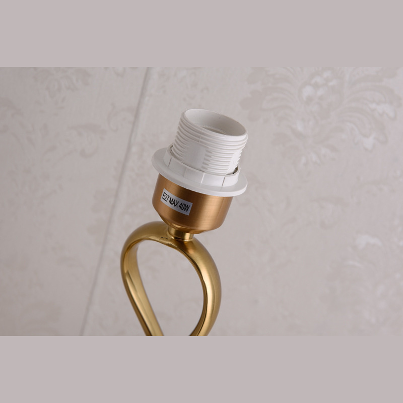 Elegant Gold LED Floor Lamp showcasing its spiral design and fabric shade in a cozy living room setting.