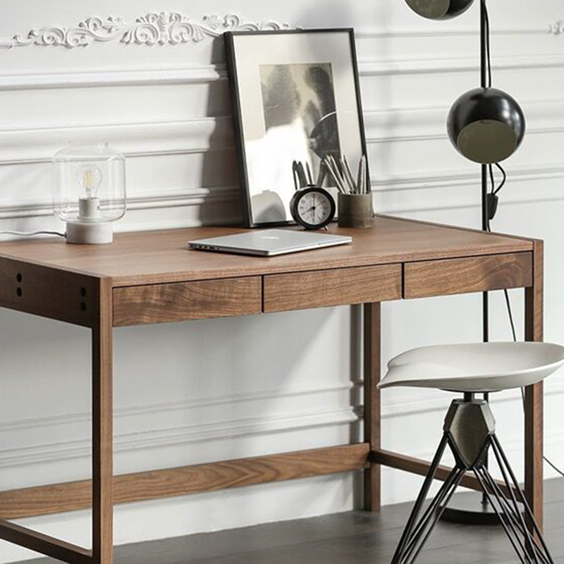 Close-up of the built-in pencil box and hidden cable management shelf of the writing desk.