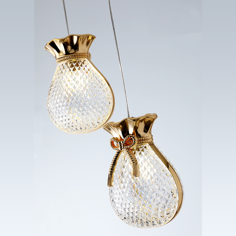 Elegant gold glass pendant light hanging in a modern dining room decor.