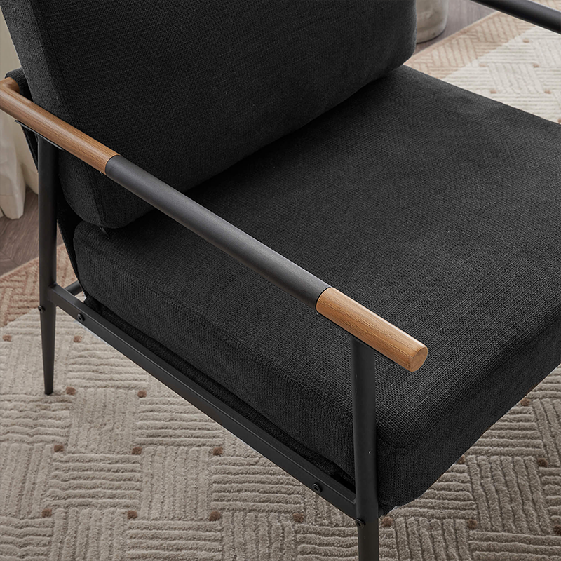 The black chenille lounge chair positioned in an office environment, showcasing its modern design.