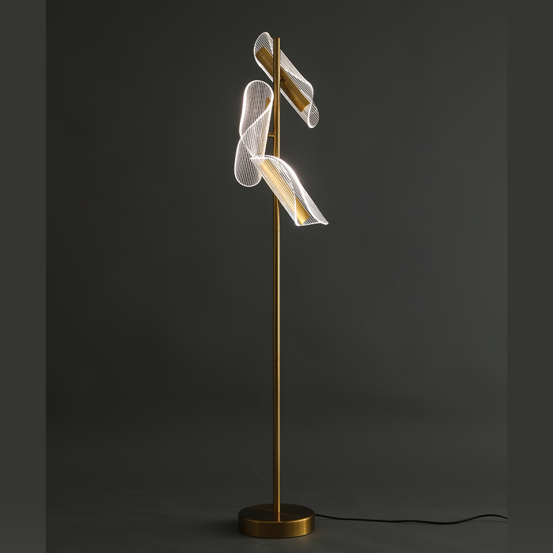 Modern brass stand LED floor lamp in a cozy reading nook, providing ambient light.