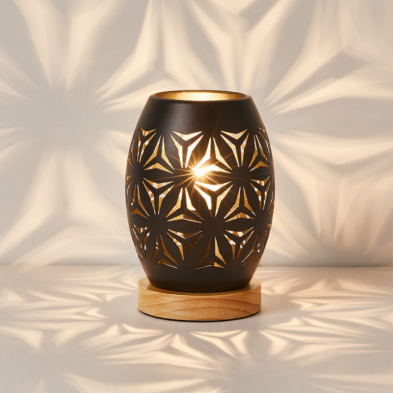 Elegant black LED decorative table lamp on a stylish coffee table, showcasing its modern design.