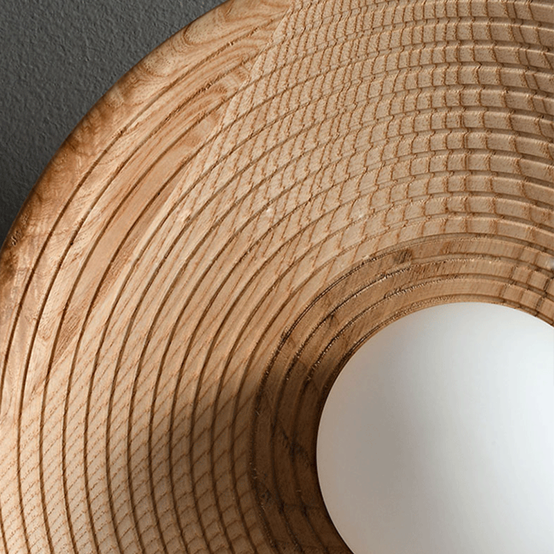 The wall lamp illuminating a bedroom with a soft, warm glow.