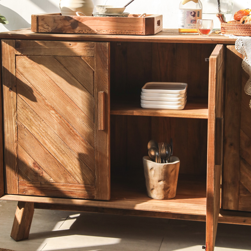 Interior view of the sideboard cabinet displaying ample storage space and woven cane front design.