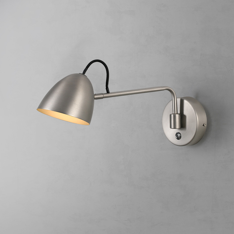 Adjustable wall light with rocker arm shown in a living room corner — top rated modern lighting for living room.