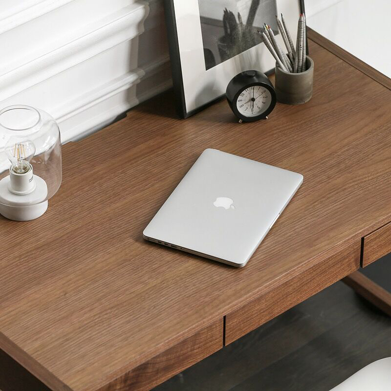 Front view of the modern walnut writing desk showing its sleek design and hidden storage.