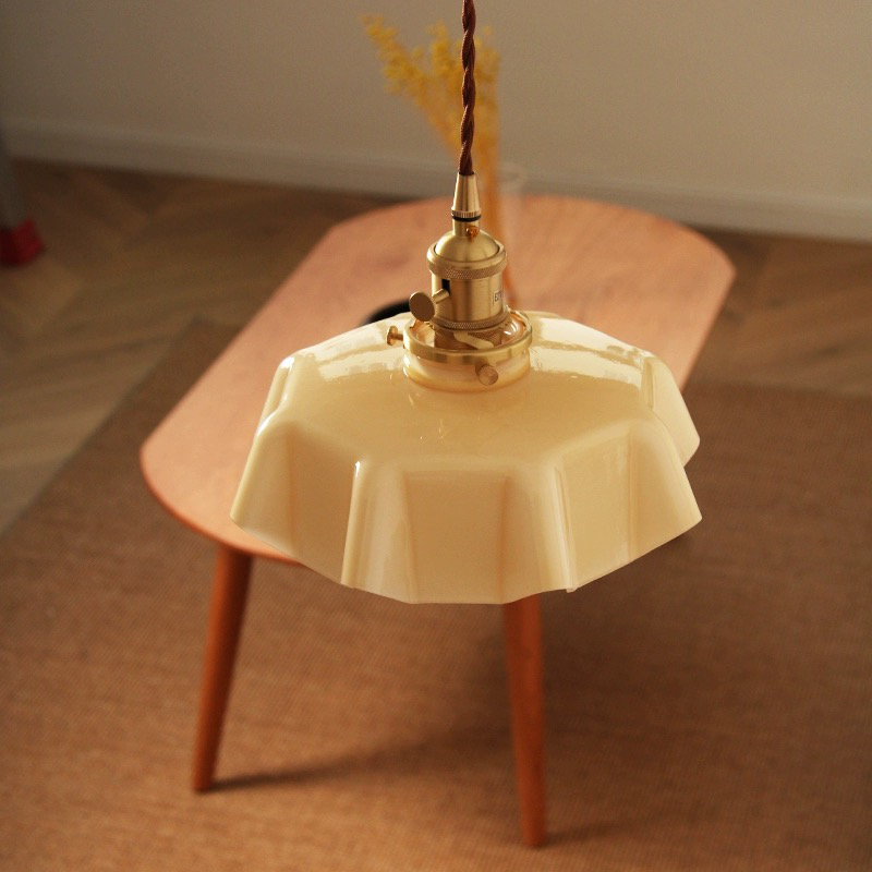 Close-up of the cream-colored glass lampshade highlighting the retro style of the pendant light.