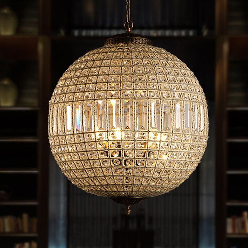 Unique crystal pendant light illuminating a chic kitchen island.