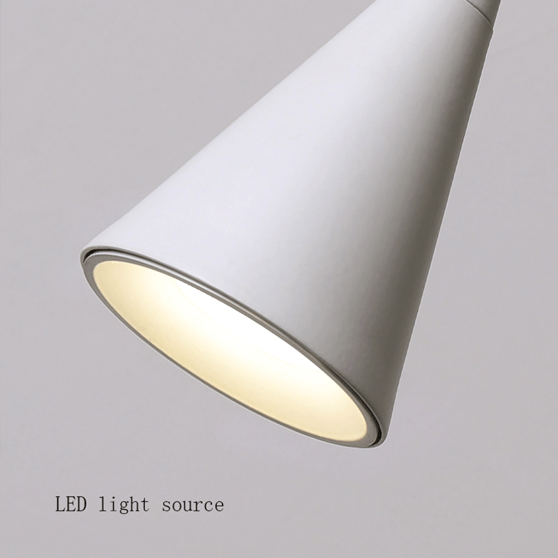 Installation of the cone-shaped LED pendant light above a stylish bar area.