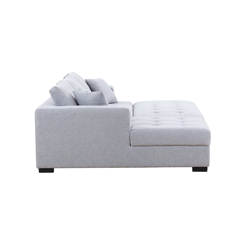 Light grey tufted sectional sofa in a contemporary living room setting