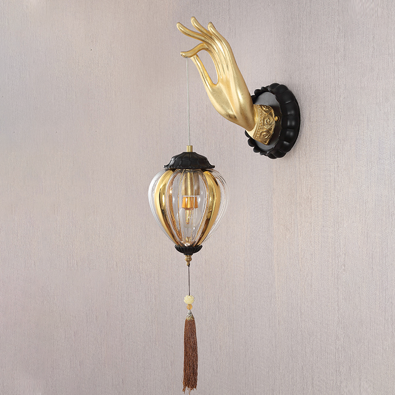 Buddha hand wall lamp displayed in a cozy bedroom setting.