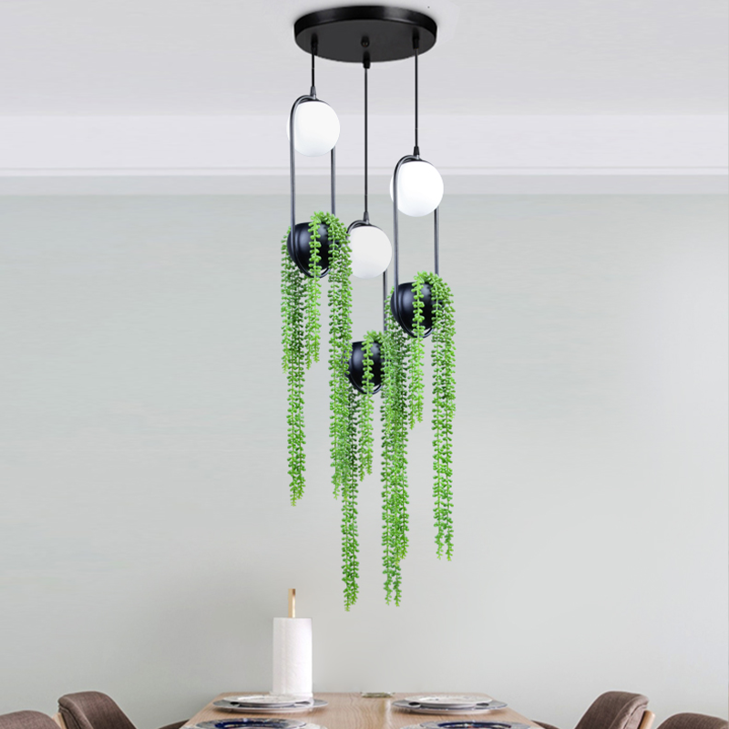 Close-up angle of the LED pendant light with adjustable ropes and potted plants.