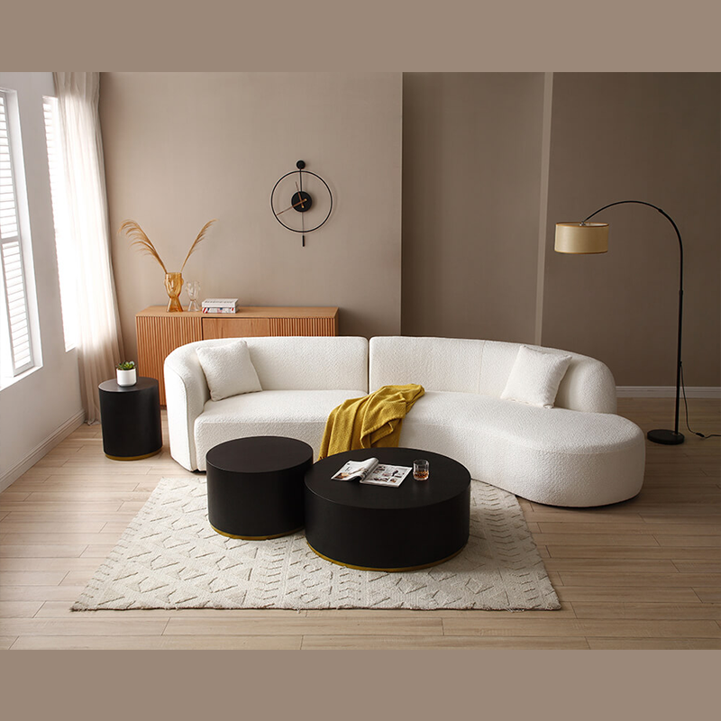 Elegant black round coffee table set in a stylish living room setting.