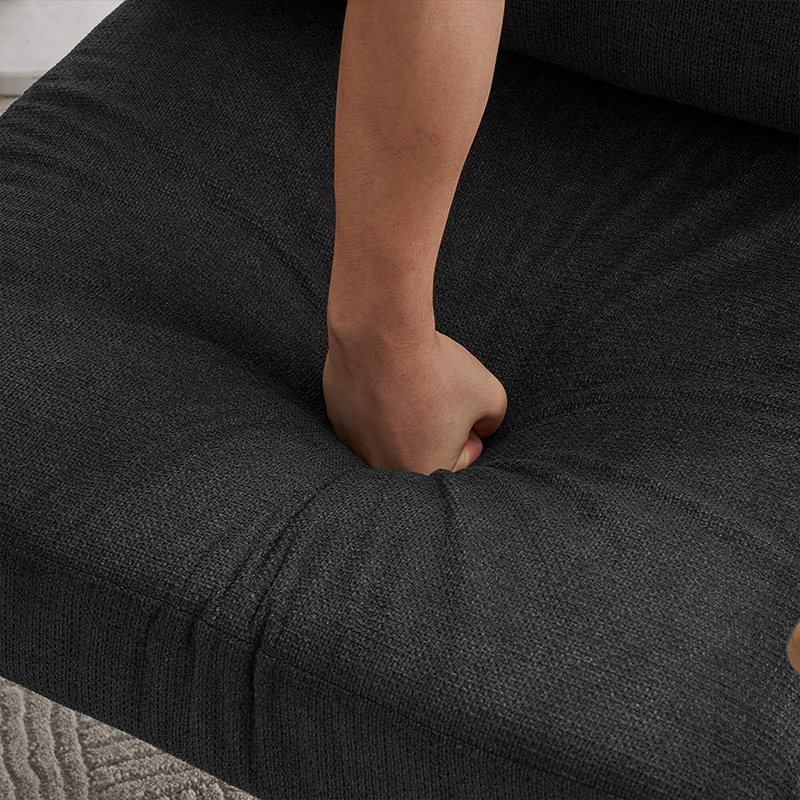 Side view of the sleek black chenille lounge chair with a metal frame in a cozy living room setting.