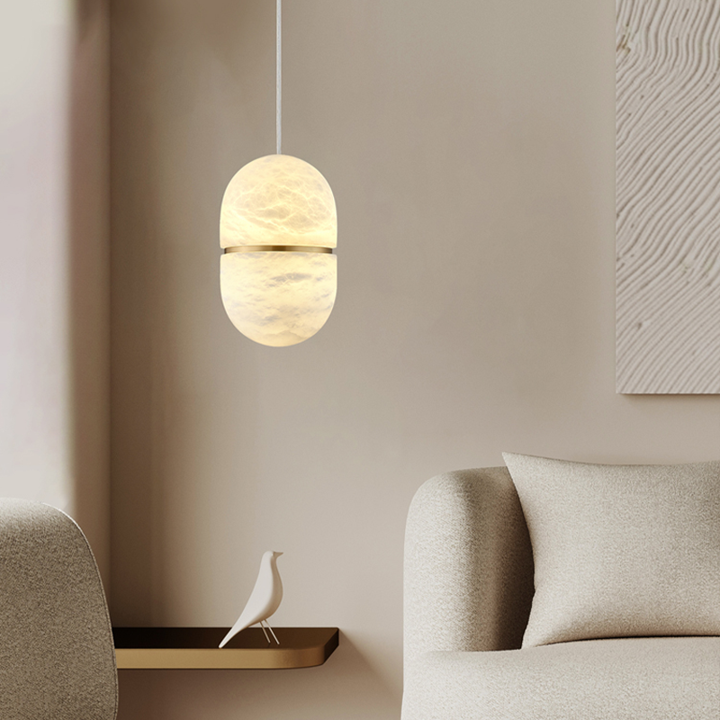 Close-up of the marble pendant light illuminating a cozy bedroom, highlighting its soft glow.