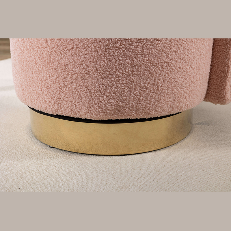 Close-up of the luxurious fabric upholstery on the pink vanity stool.