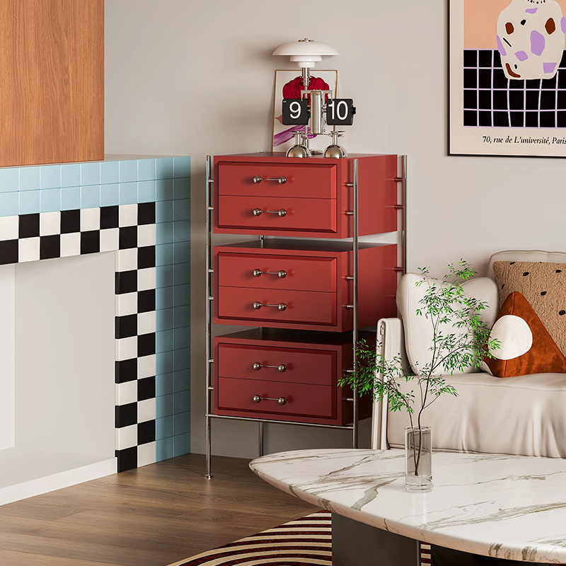 Stylish storage cabinet placed in an entryway, displaying lamps and books.