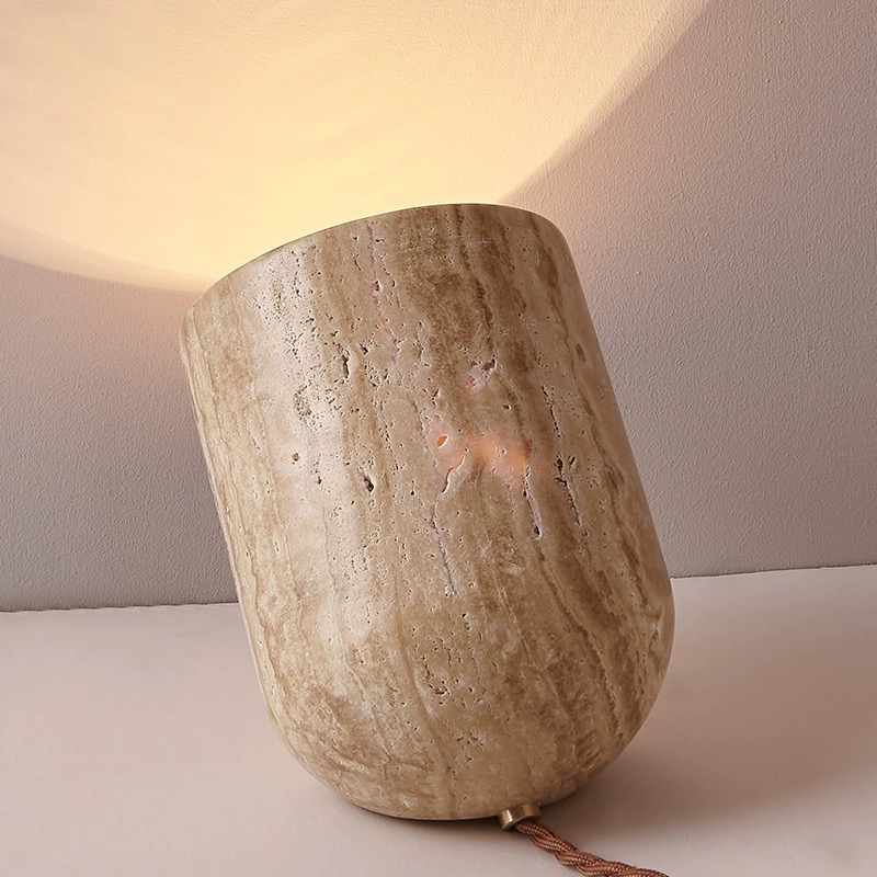 Table lamp on a bedside table, creating a warm ambiance in a cozy bedroom.